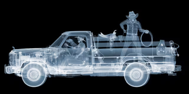 A Nick Veasey limited edition Chromaluxe Xray of a truck with two cowboys on board and a dog in the front seat, the title is 1986 Dodge Ram Cowboys