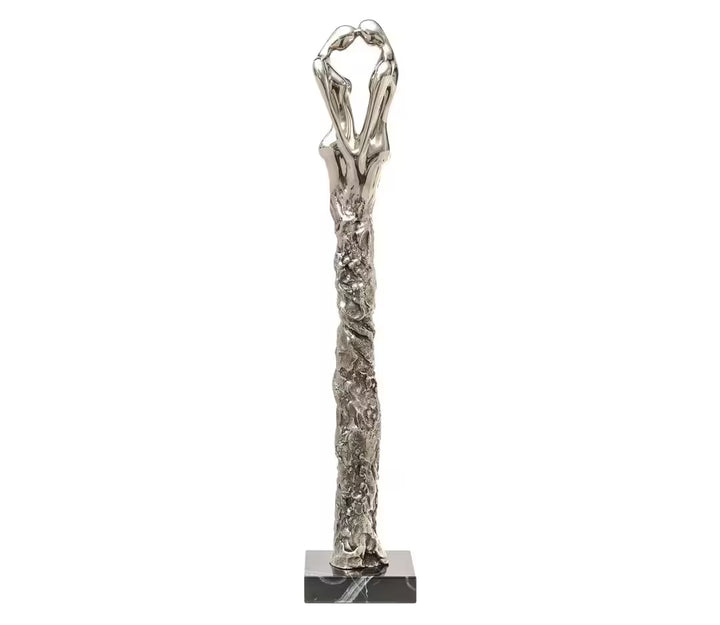 A Jennine Parker limited edition sculpture of two people with their heads together and their legs merging together, the title is Adoration II