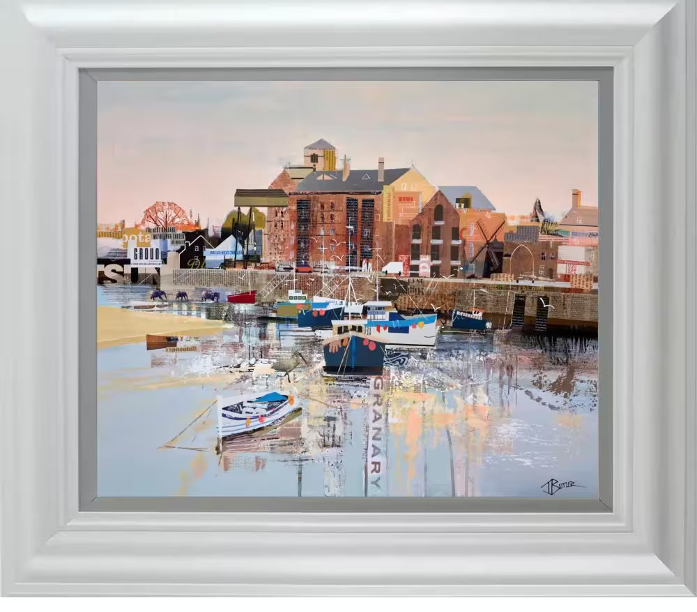 A Tom Butler framed limited edition hand embellished print of Wells-Next-The-Sea, it shows a collage of the Granary with boats docked in front of it, the title is All's-Well-Next-The-Sea