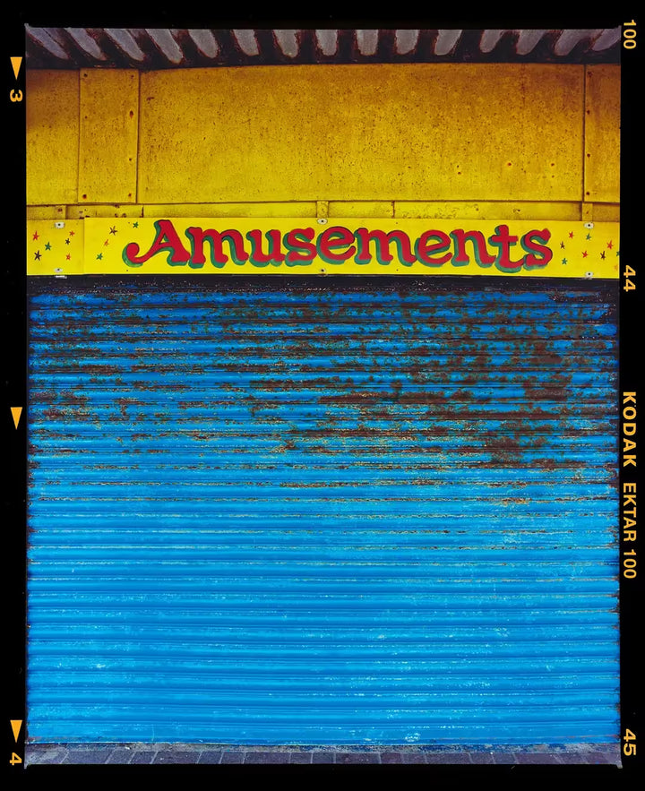 A limited edition photograph by Richard Heeps using vibrant colours, the title is Amusements, Porthcawl, 2023