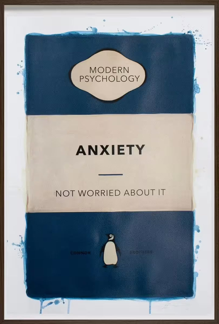 A limited edition framed print by The Connor Brothers of a penguin book cover with a witty line across the front, the title is Anxiety