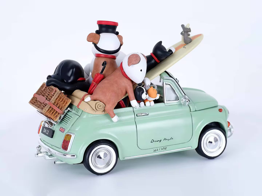 A Doug Hyde porcelain sculpture of a person in a green car with dogs and cats and beach items in the car, the title is Beach Buddies