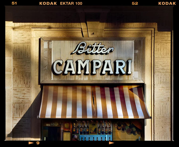A limited edition photograph by Richard Heeps using vibrant colours, the title is Bitter Campari Sign