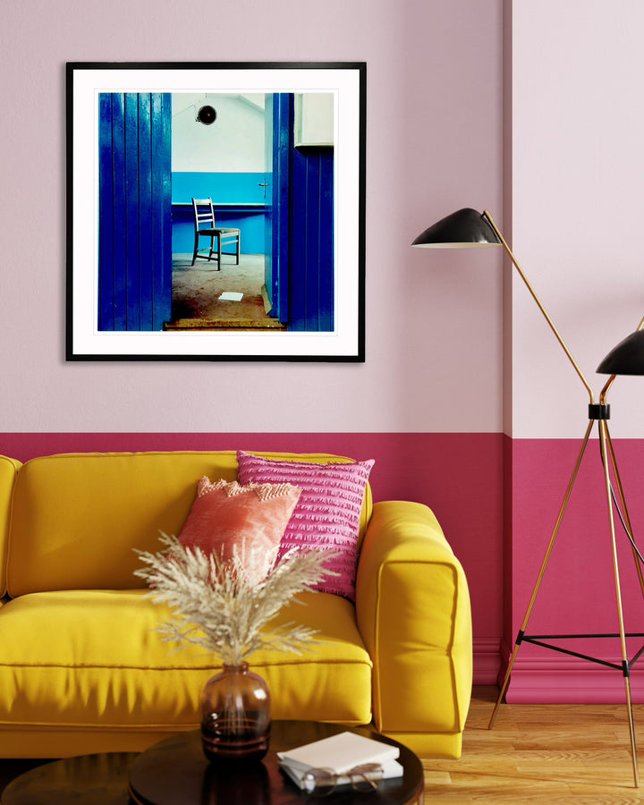 Chair, Northwich, 1986 by Richard Heeps displayed on a baby pink wall with a yellow sofa in the foreground