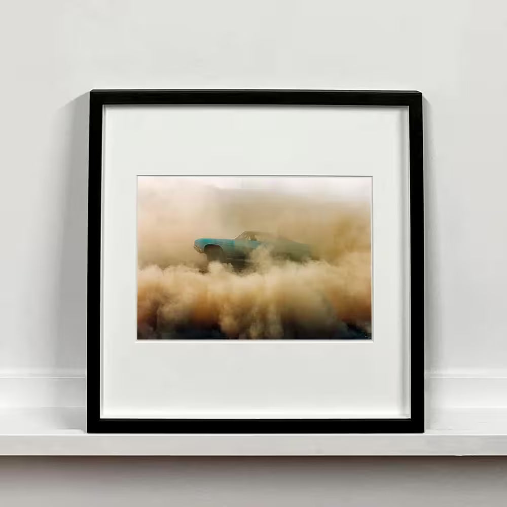 A framed limited edition photograph by Richard Heeps using vibrant colours, the title is Buick In The Dust I, Hemsby, Norfolk, 2000