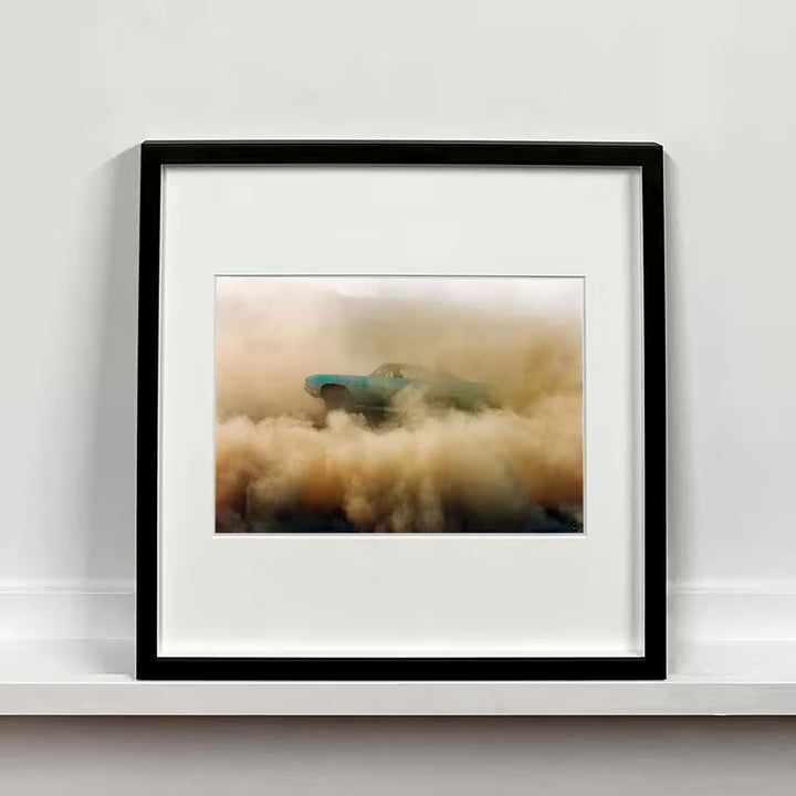 A framed limited edition photograph by Richard Heeps using vibrant colours, the title is Buick In The Dust I, Hemsby, Norfolk, 2000