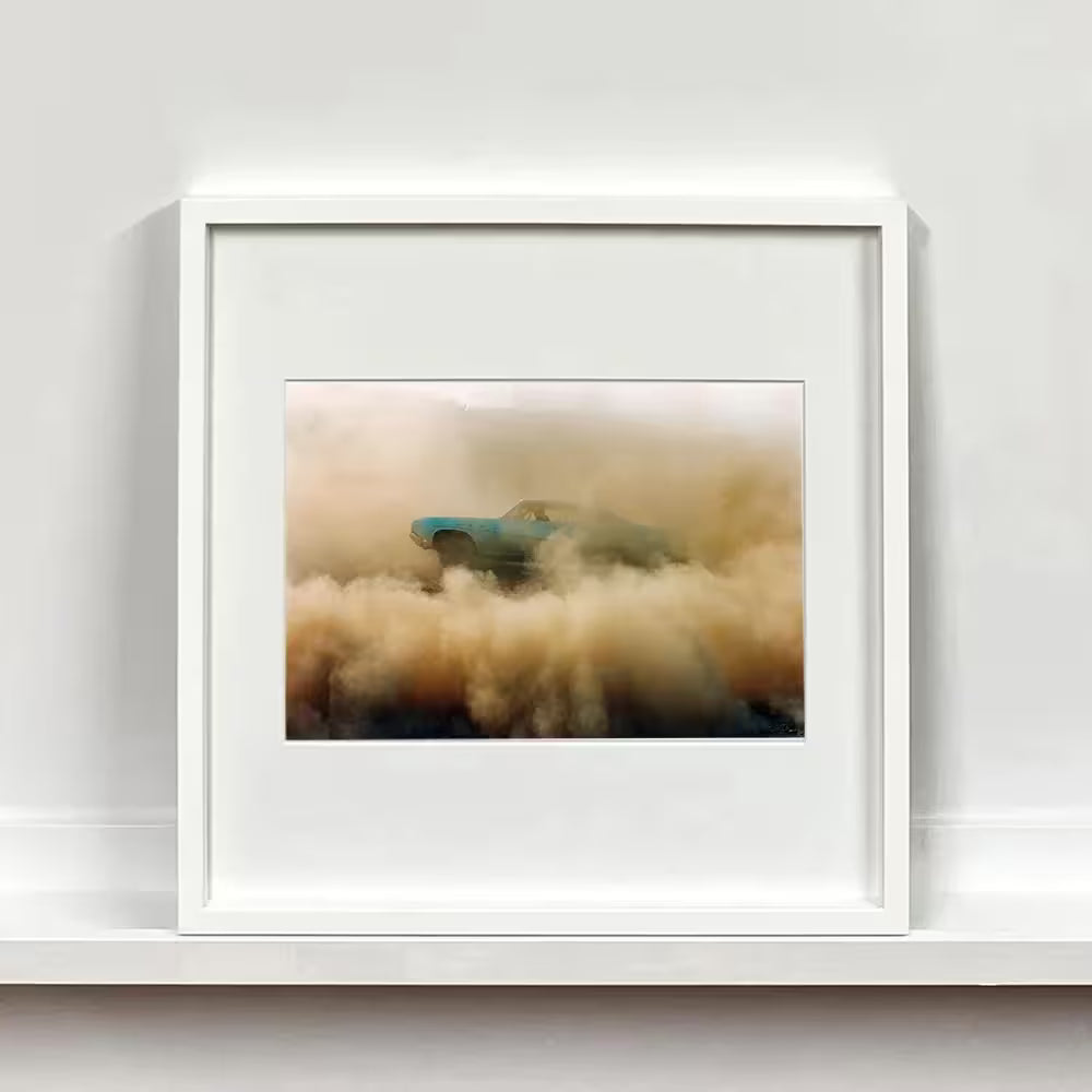A framed limited edition photograph by Richard Heeps using vibrant colours, the title is Buick In The Dust I, Hemsby, Norfolk, 2000