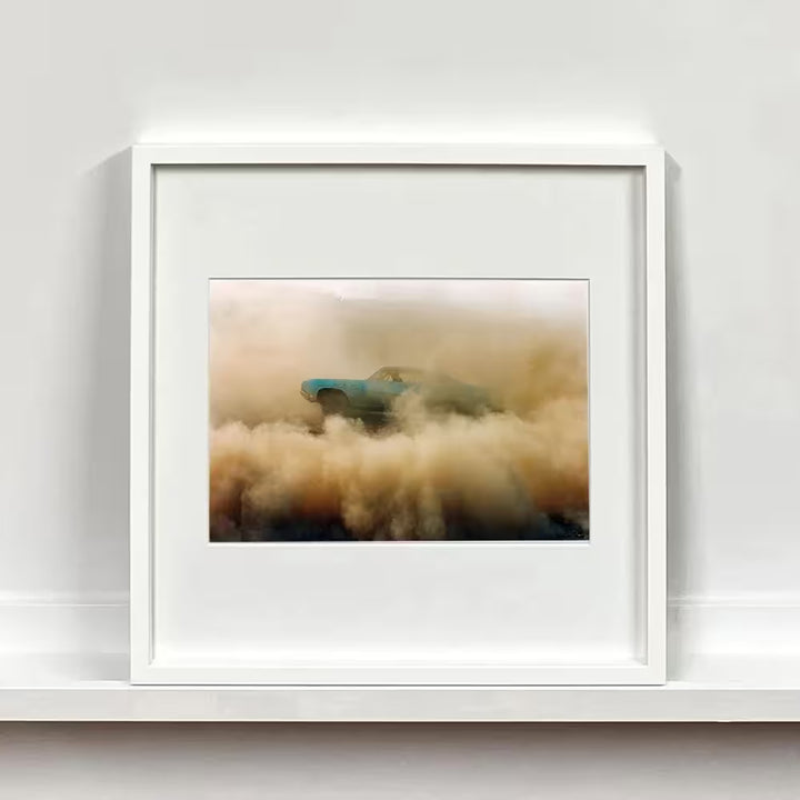 A framed limited edition photograph by Richard Heeps using vibrant colours, the title is Buick In The Dust I, Hemsby, Norfolk, 2000