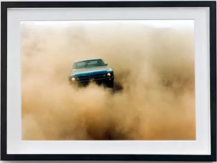 A framed limited edition photograph by Richard Heeps using vibrant colours, the title is Buick In The Dust II, Hemsby, Norfolk, 2000