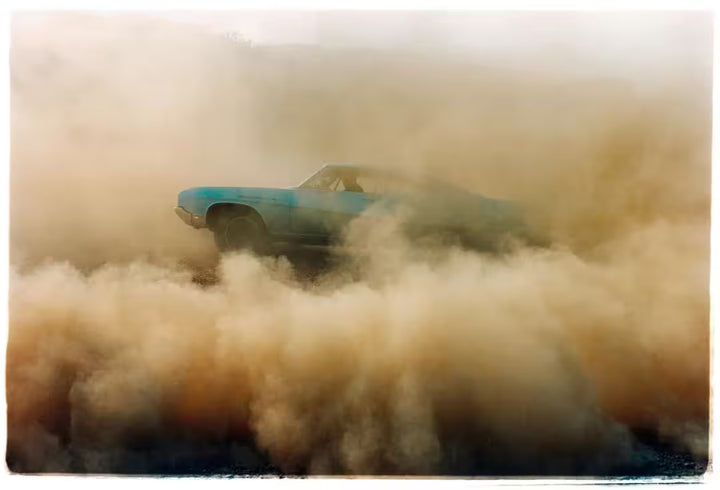 A limited edition photograph by Richard Heeps using vibrant colours, the title is Buick In The Dust I, Hemsby, Norfolk, 2000