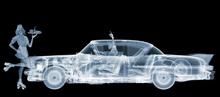 A limited edition Chromaluxe print by Nick Veasey of an X-Rayed vehicle and a roller watress infront of the car, the title is Cadillac Car Hop