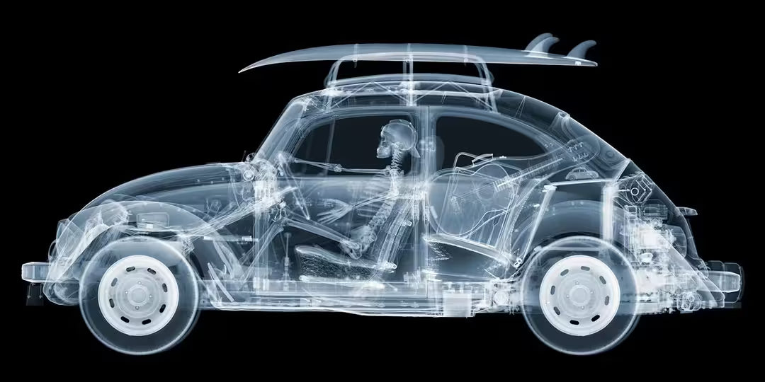 A limited edition Chromaluxe print by Nick Veasey of an X-Rayed vehicle with a skeleton sat in the front seat driving, the title is California Bug
