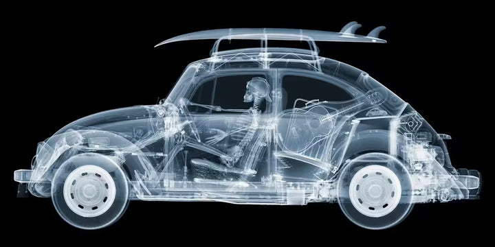A limited edition Chromaluxe print by Nick Veasey of an X-Rayed vehicle with a skeleton sat in the front seat driving, the title is California Bug