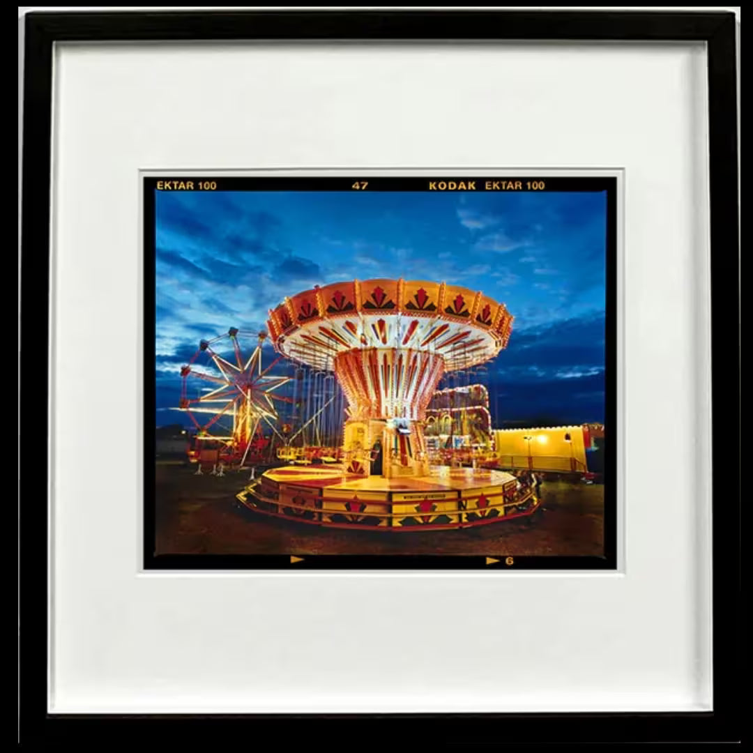 A framed limited edition photograph by Richard Heeps using vibrant colours, the title is Chairoplanes, Haddenham, 2022