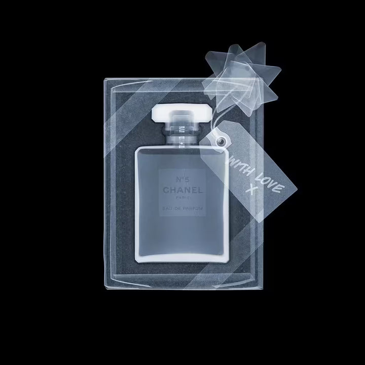 A limited edition Chromaluxe lenticular print by Nick Veasey of an X-Rayed Chanel No5 bottle in gift wrap, the title is Chanel No5- Black and White