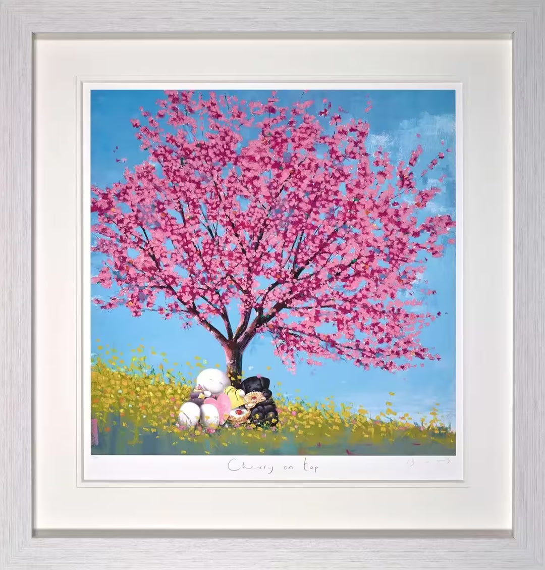 A framed Doug Hyde limited edition print of a large cherry blossom tree with a person and a black dog sat underneath holding a selection of confectionary, title is Cherry on Top