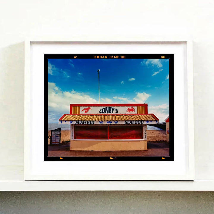 A white framed limited edition photograph by Richard Heeps using vibrant colours, the title is Coney&