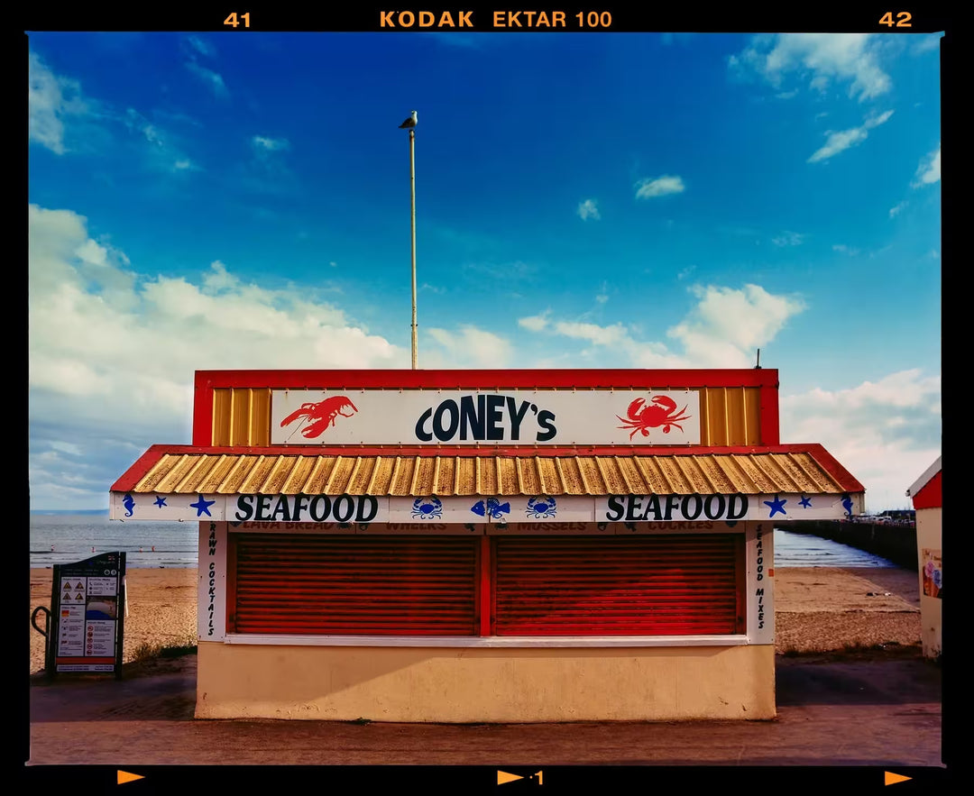 A limited edition photograph by Richard Heeps using vibrant colours, the title is Coney's, Porthcawl, 2023
