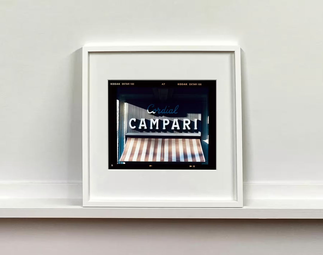A white framed limited edition photograph by Richard Heeps using vibrant colours, the title is Cordial Campari