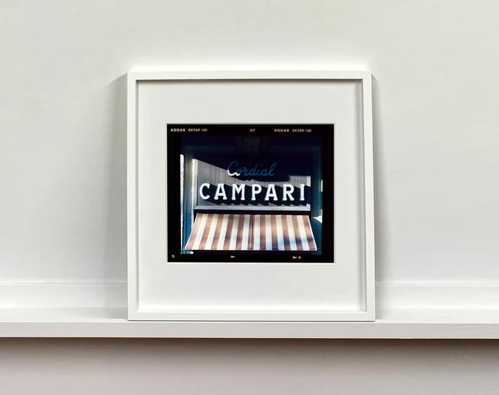 A white framed limited edition photograph by Richard Heeps using vibrant colours, the title is Cordial Campari