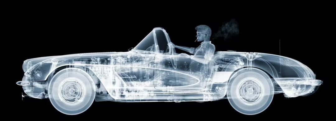 A limited edition Chromaluxe print by Nick Veasey of an X-Rayed vehicle with a skeleton sat in the front seat driving, the title is Corvette Cruiser