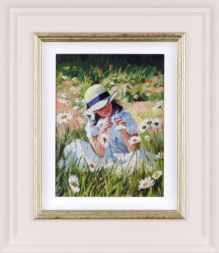 A Sherree Valentine Daines framed limited edition of a girl in a summer dress and hat playing with daisies, the title is Daisy Whispers