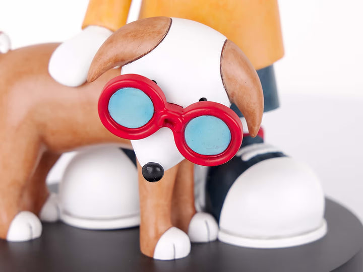 A Doug Hyde limited edition porcelain sculpture of a person making a peace sign with their dog in matching glasses, the title is Double Trouble
