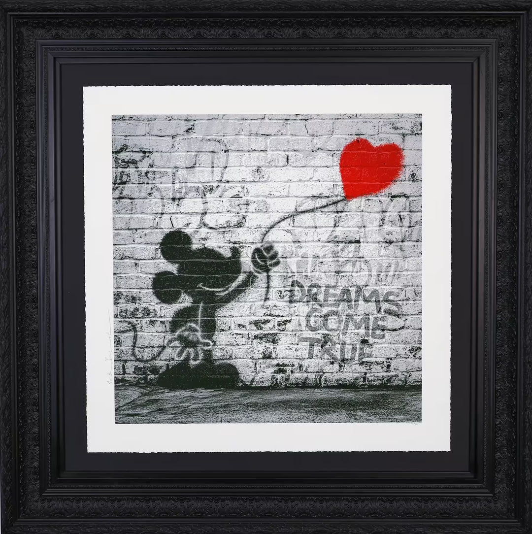A Mr Brainwash framed limited edition of a grey wall with Mickey Mouse holding onto a red balloon spray painted onto it, the title is Dreams Come True (Deluxe)