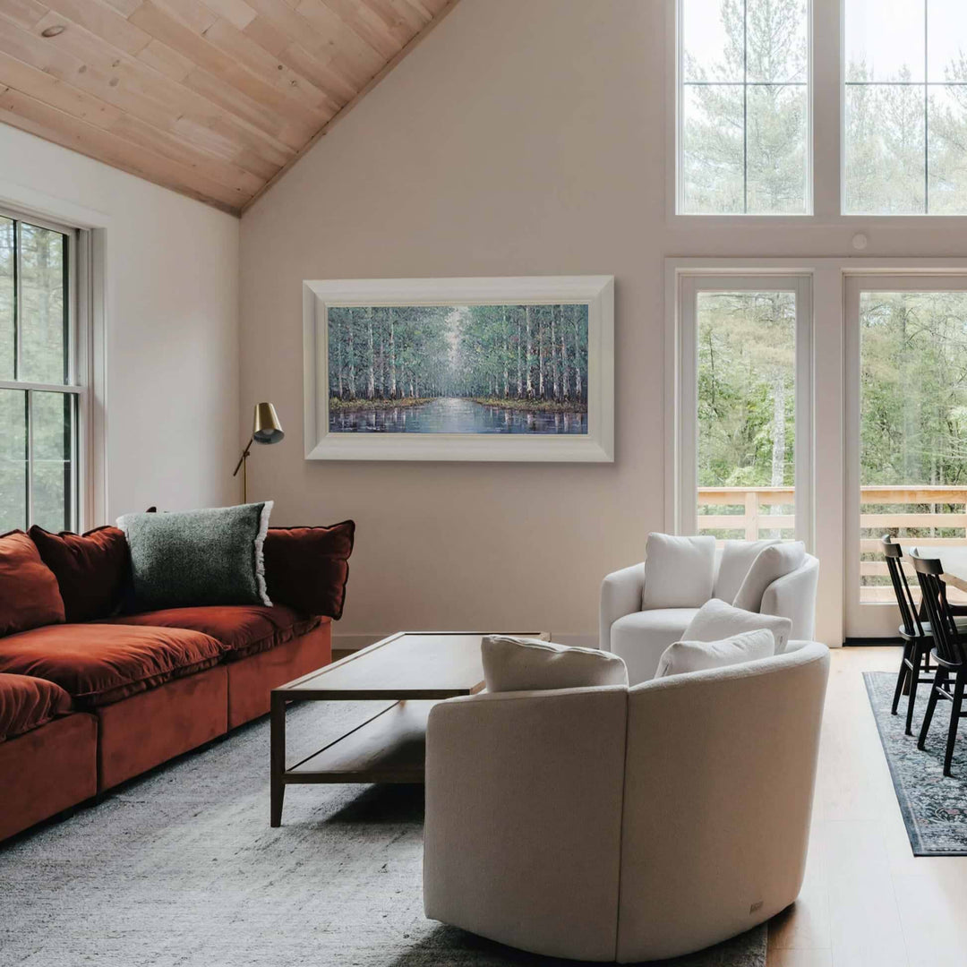 Modern living room with a red sofa, white armchair, and large windows, featuring rt by Inam