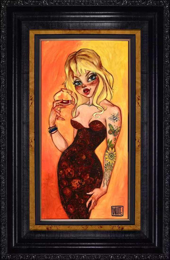 A Todd White framed limited edition of a blonde lady in a red dress with a sleeve of tattoos drinking wine, the title is Even Broken Crayons Still Colour