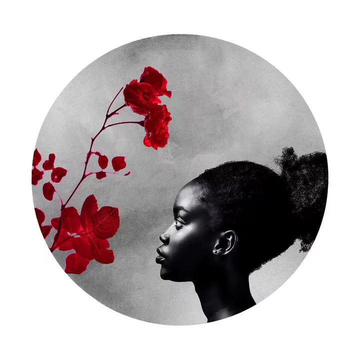 A Maxim limited edition of a red flower and a girl looking onto it, the title is Exhale