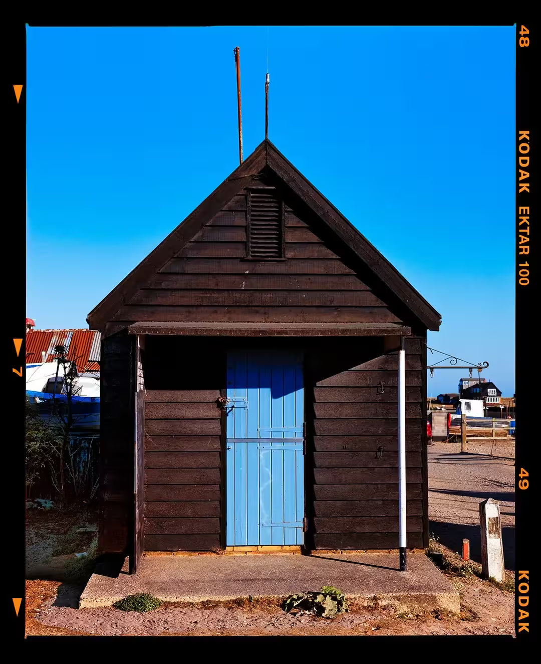A limited edition photograph by Richard Heeps using vibrant colours, the title is Fishing Hut, Southwold, Suffolk, 2022