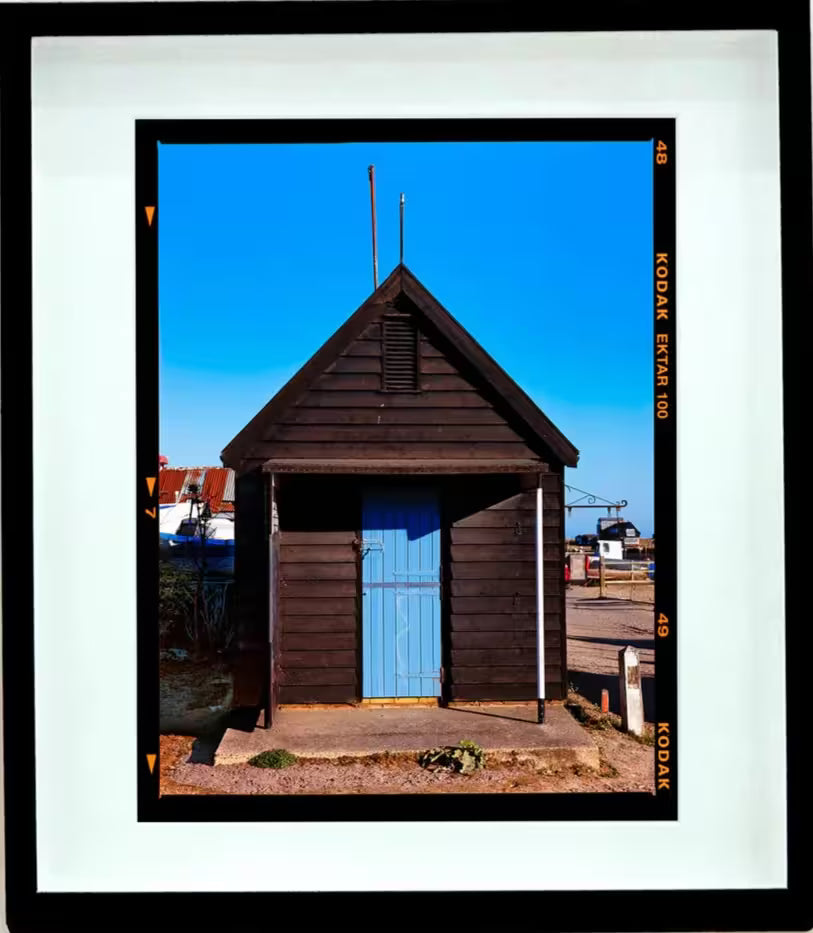 A framed limited edition photograph by Richard Heeps using vibrant colours, the title is Fishing Hut, Southwold, Suffolk, 2022
