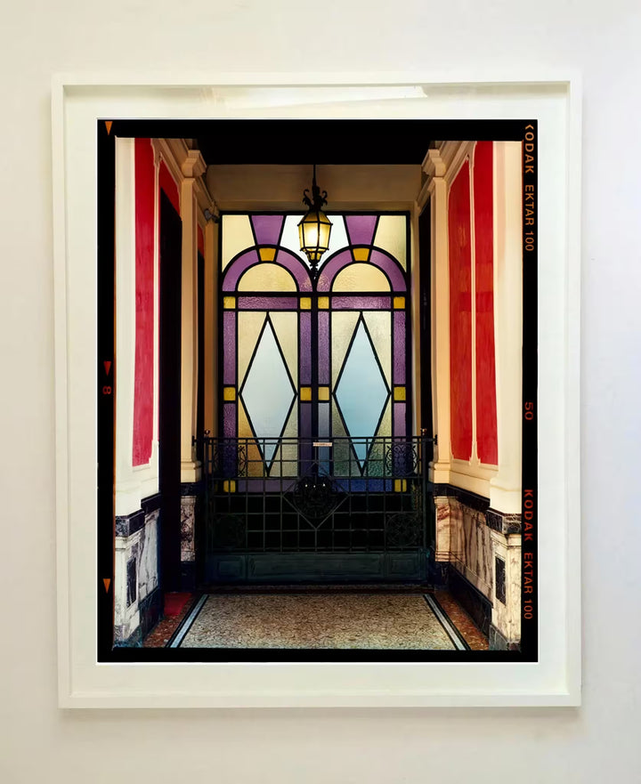 A white framed limited edition photograph by Richard Heeps using vibrant colours, the title is Foyer VII, Milan, 2020