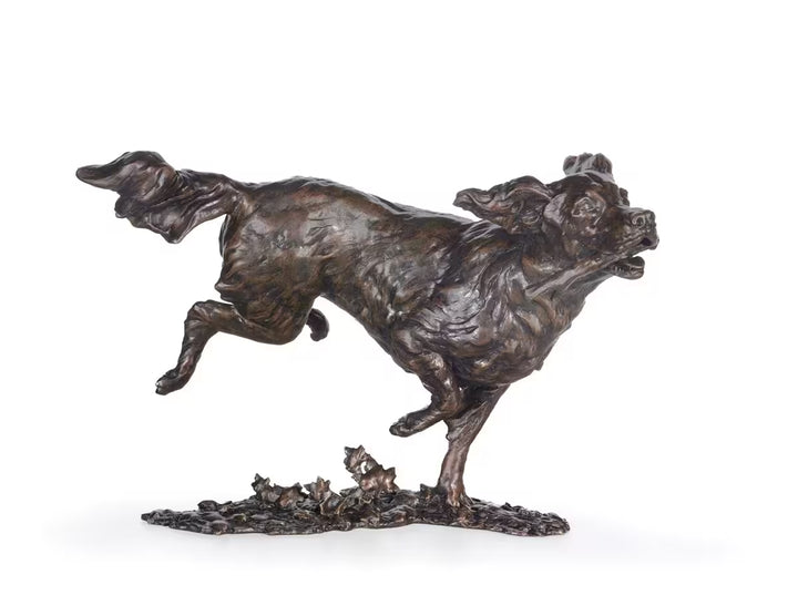 Bronze sculpture of a dog running with a smaller figure on a white background, Free Spirit by Dean Kendrick