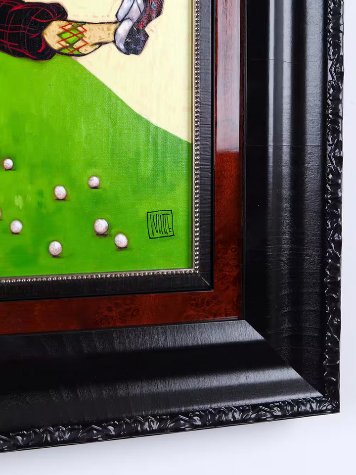 Framed artwork of a golf scene with a signature in the corner.