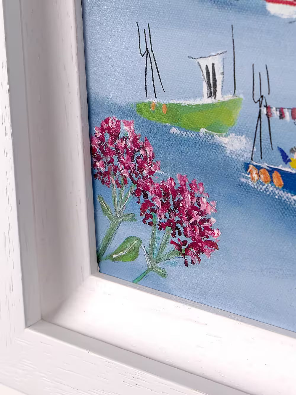 A Rebecca Lardner limited edition of a few houses on a stone cliff behind a beach with boats pulling in and people, the title is Harbour Hideaway II