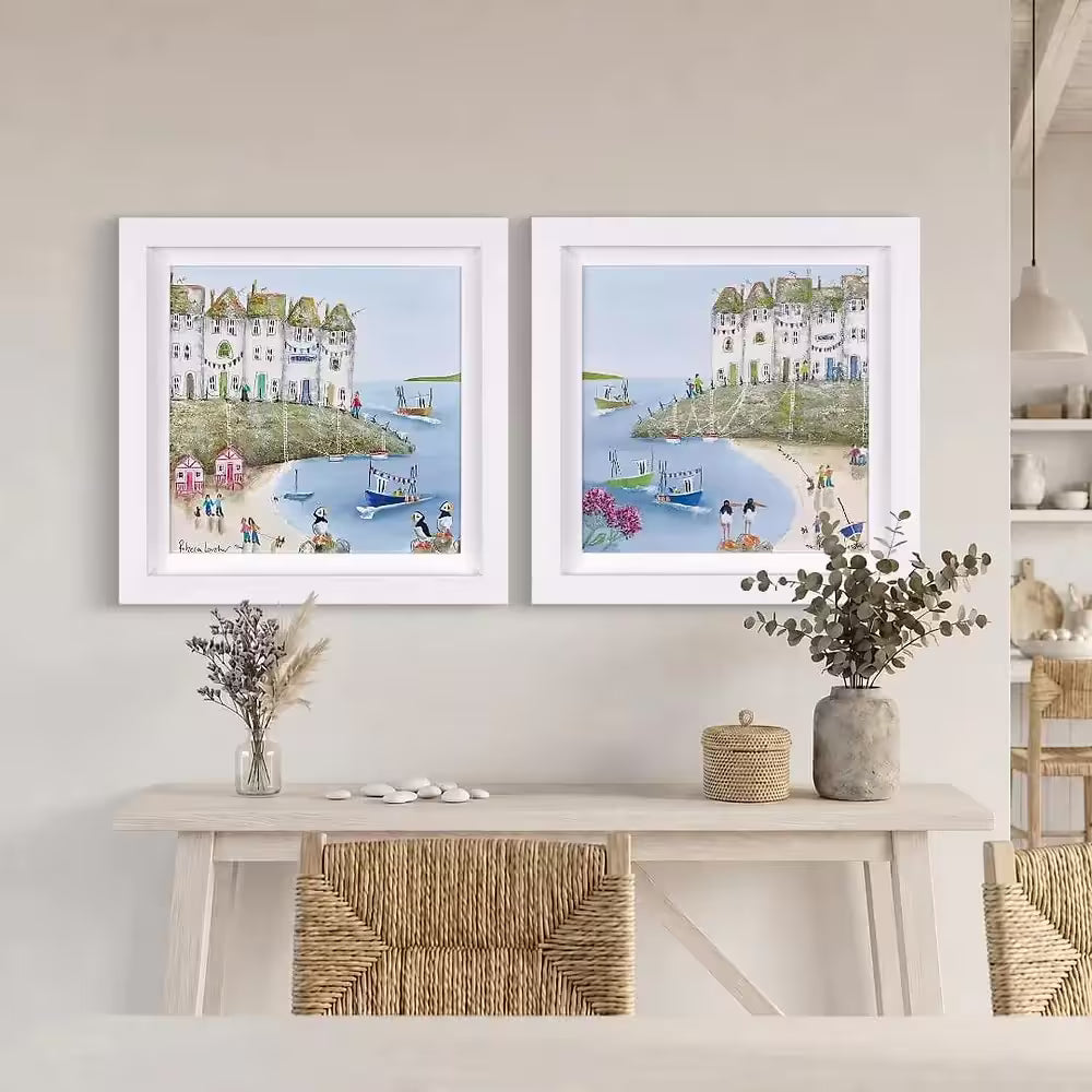 A Rebecca Lardner limited edition of a row of houses behind a beach with pink beach huts and boats pulling in, the title is Harbour Hideaway I