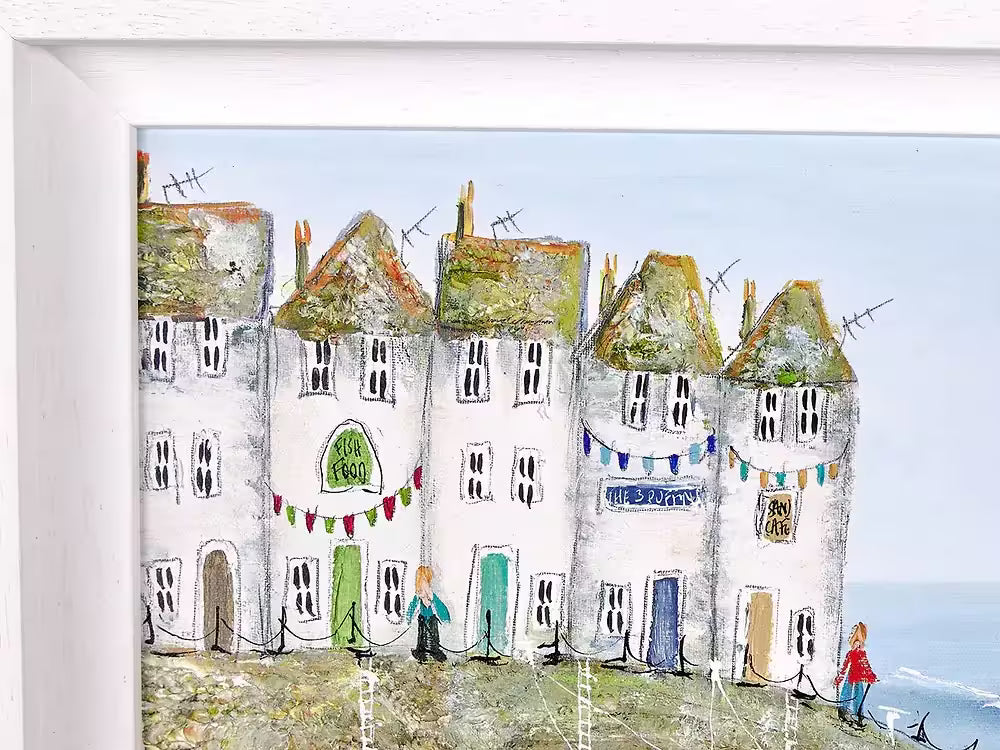 A Rebecca Lardner limited edition of a row of houses behind a beach with pink beach huts and boats pulling in, the title is Harbour Hideaway I