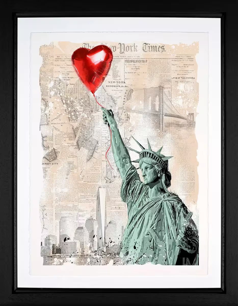A Mr Brainwash framed limited edition print of the Statue of Liberty holding onto a red heart balloon against a background made of newspaper clippings of New York, the title is Heart and Soul