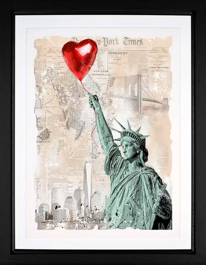 A Mr Brainwash framed limited edition print of the Statue of Liberty holding onto a red heart balloon against a background made of newspaper clippings of New York, the title is Heart and Soul