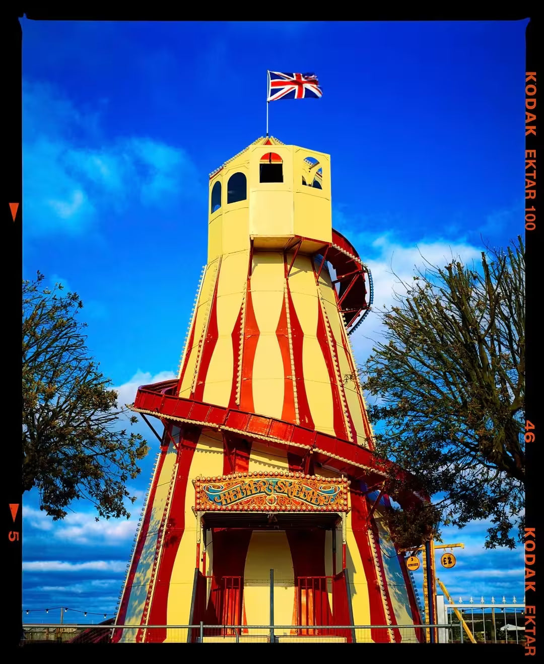 A limited edition photograph by Richard Heeps using vibrant colours, the title is Helter Skelter, Great Yarmouth, 2023