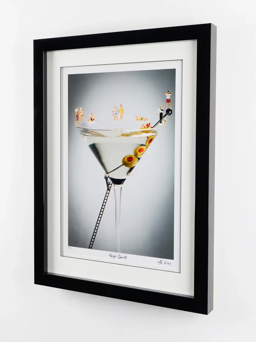 A Mr Kuu limited edition piece of a martini glass with people around it in bathing suits, the title is High Spirits