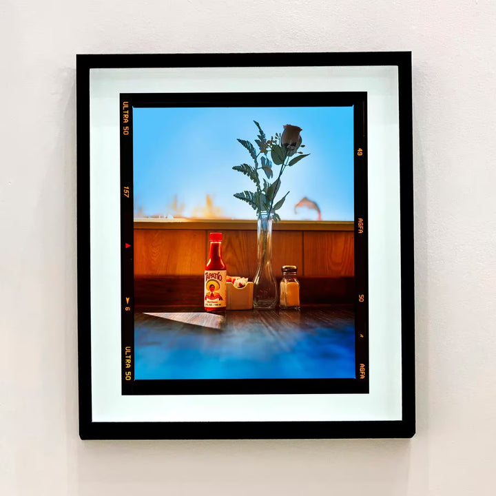 A framed limited edition photograph by Richard Heeps using vibrant colours, the title isHot sauce, Lone Pine, California, 2001