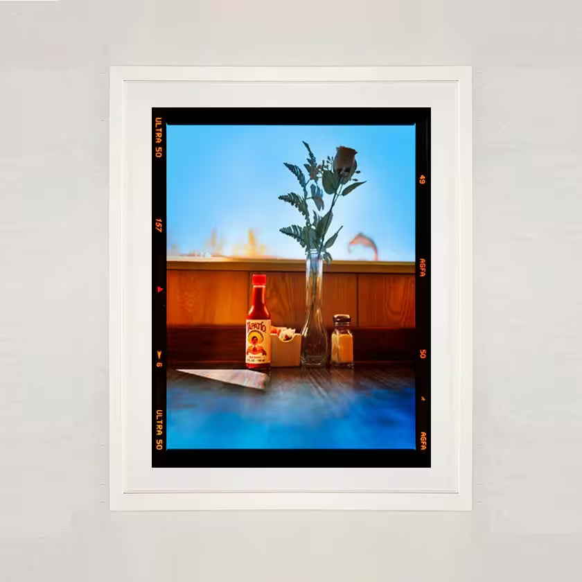 A white framed limited edition photograph by Richard Heeps using vibrant colours, the title isHot sauce, Lone Pine, California, 2001