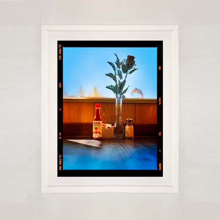 A white framed limited edition photograph by Richard Heeps using vibrant colours, the title isHot sauce, Lone Pine, California, 2001