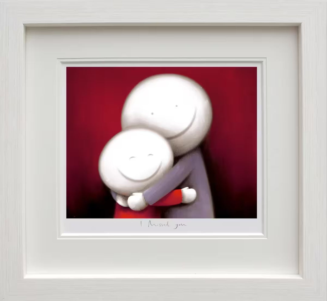 A Doug Hyde framed limited edition of a person in purple hugging a smaller person in red, the title is I Missed You