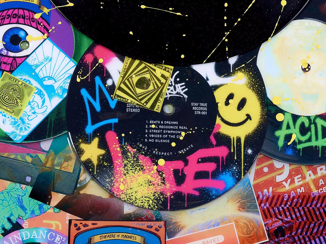 A limited edition mixed media piece by Dan Pearce of lots of differrent vinyl records with spraypaint and designs all over them, the title is In The Mix