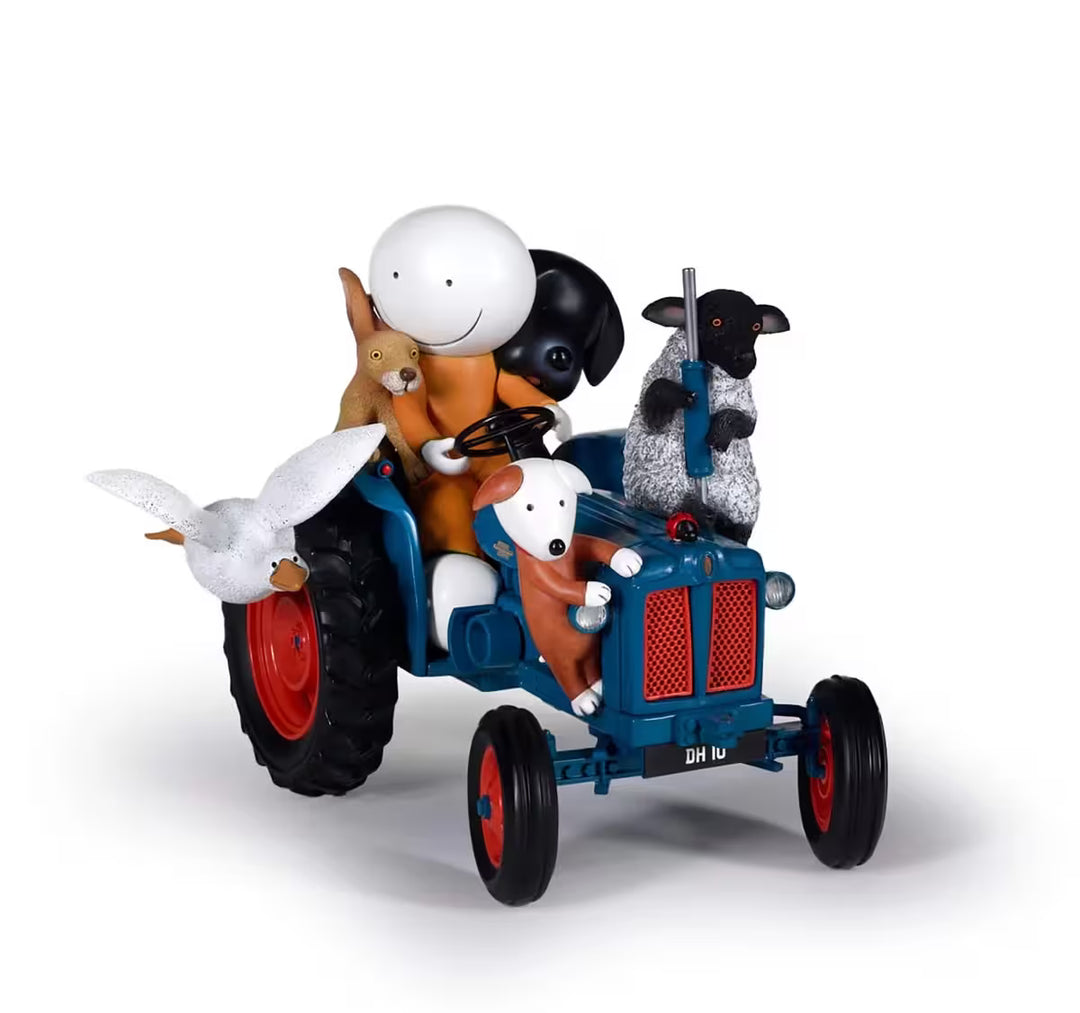 A sculpture by Doug Hyde of a person in orange on a tractor with a sheep, goose, hare, and two dogs, the title is Joyride