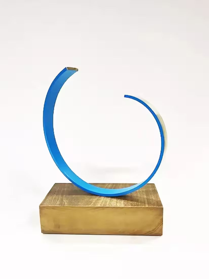 A Gareth Griffiths original sculpture of a blue spiral with a gold band around it, the title is La Onda